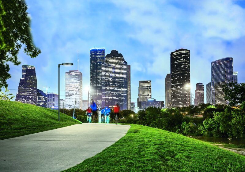 Houston city skyline at night & people in park